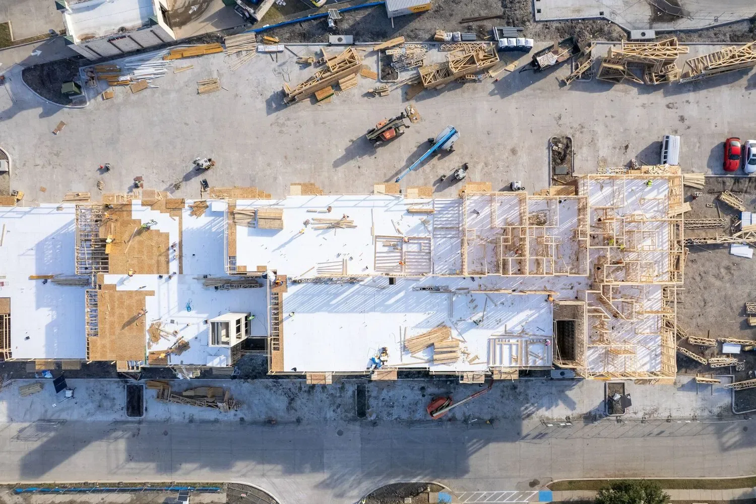 Aerial view of a commercial construction site showing structural framing and layout for progress tracking.