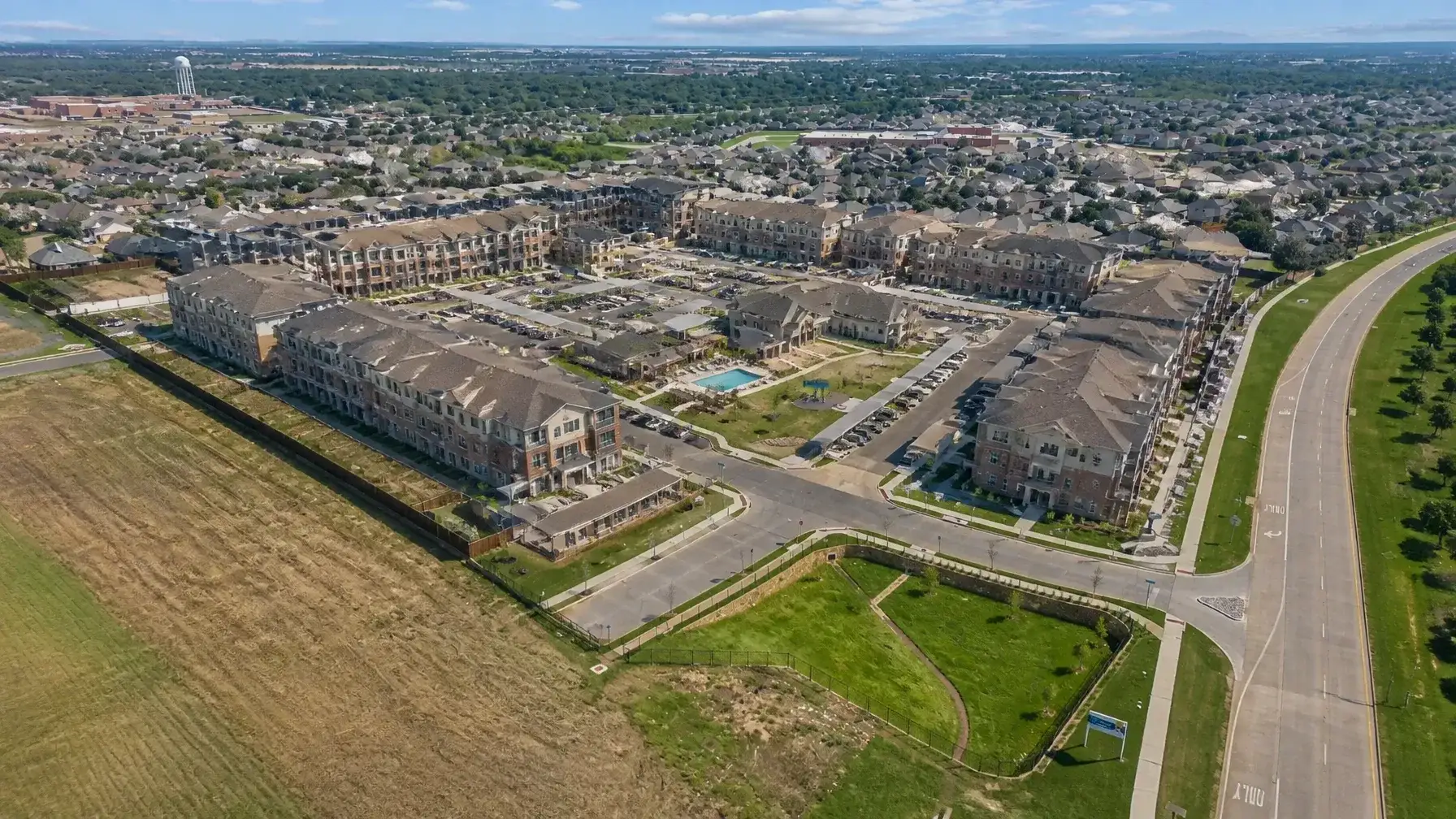 Aerial view of a modern multifamily apartment complex showing building layouts and amenities.